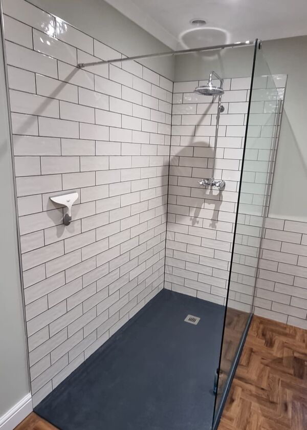 After photo - Expansive shower with elegant black tray.