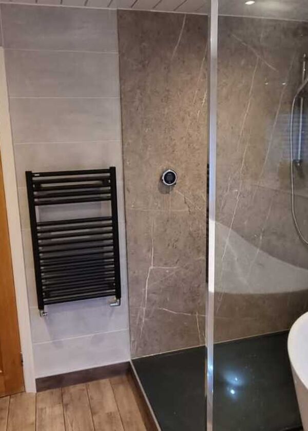 After photos - Modern bathroom redesign with stylish tiles and towel rail