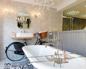 Frosted glass door with the logo "Distinct Bathrooms" and an image of a bathroom fixture.
